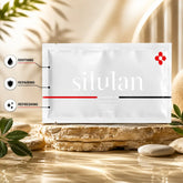 Siluan skincare sheet mask packet displayed on a stone pedestal with decorative leaves, featuring soothing, repairing, and refreshing skincare benefits.