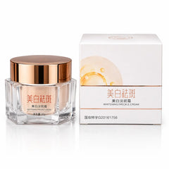 Front view of Whitening Freckle Cream 50g glass jar with rose gold lid and matching product box for reducing freckles, dark spots, and promoting an even skin tone.